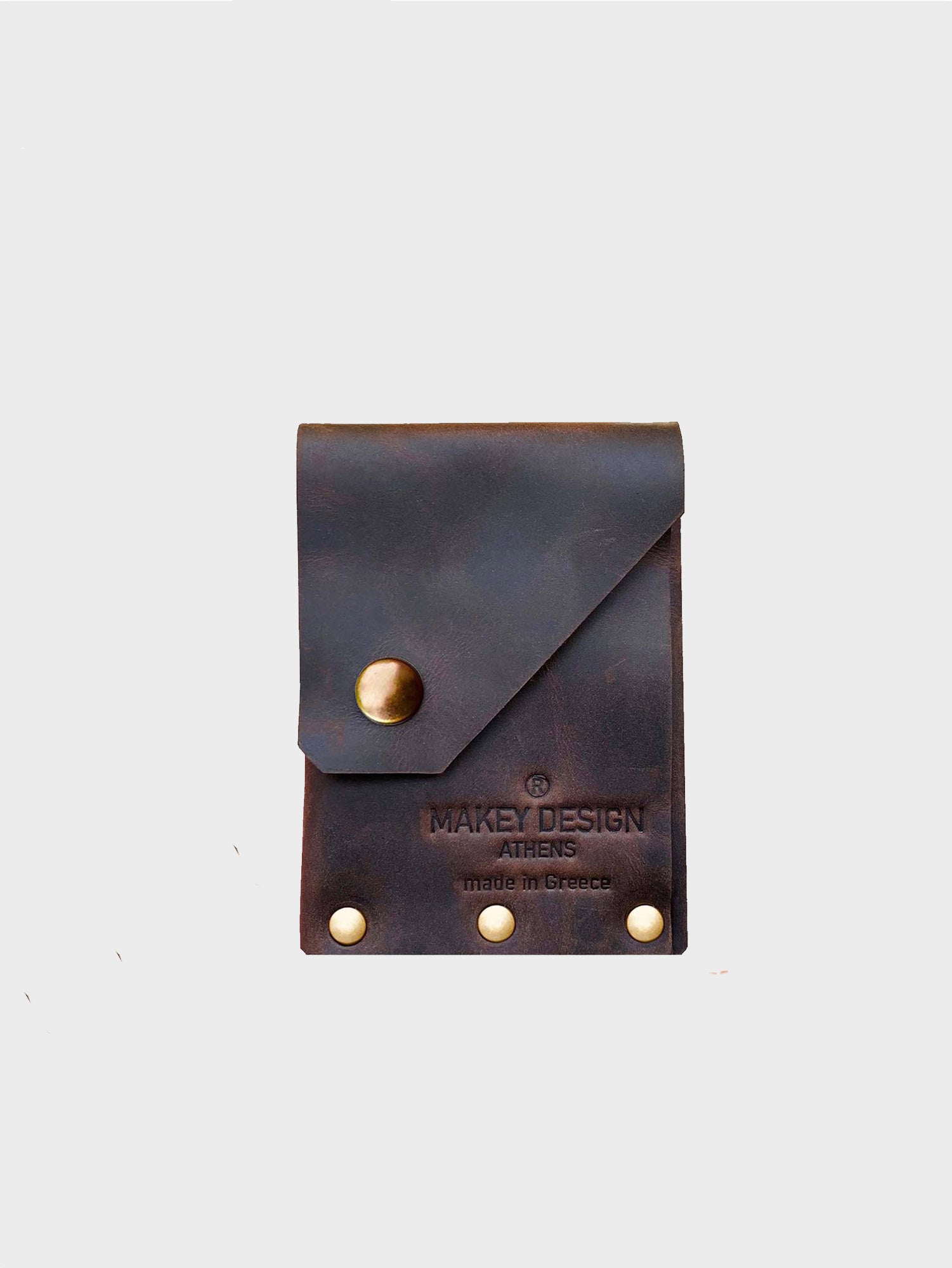 Brown leather pouch with gold buttons on a white background, featuring 'Makey Design' branding.