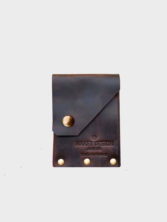 Brown leather pouch with gold buttons on a white background, featuring 'Makey Design' branding.