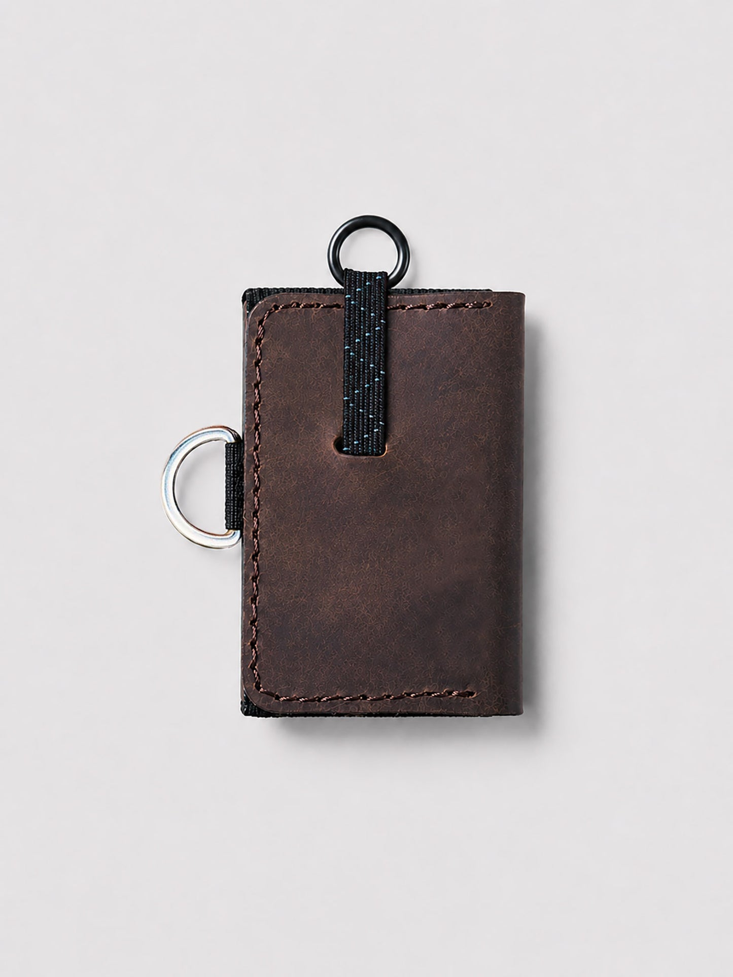 Brown leather wallet with a keychain on a light gray background