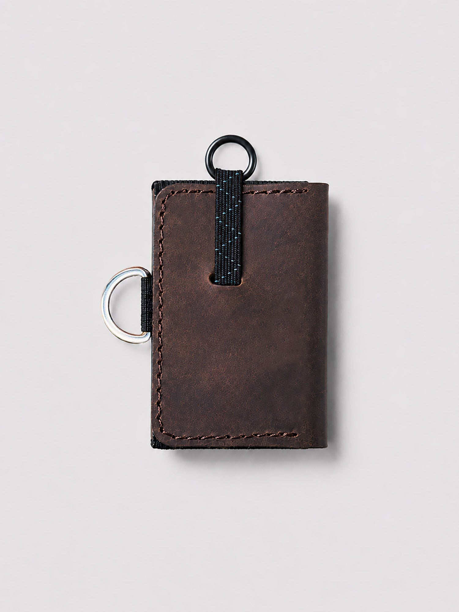 Brown leather wallet with a keychain on a light gray background