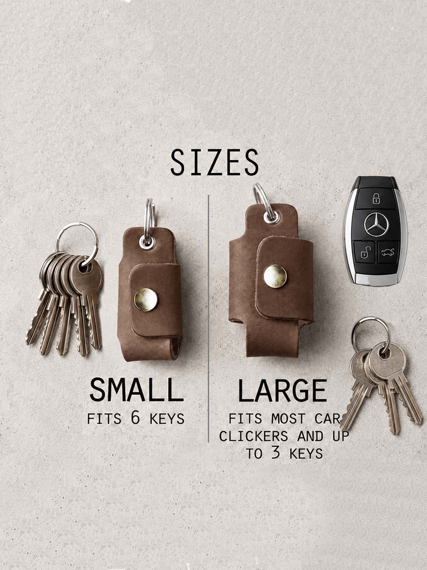 Two leather key holders, one small and one large, with keys and a car key fob on a light gray background.